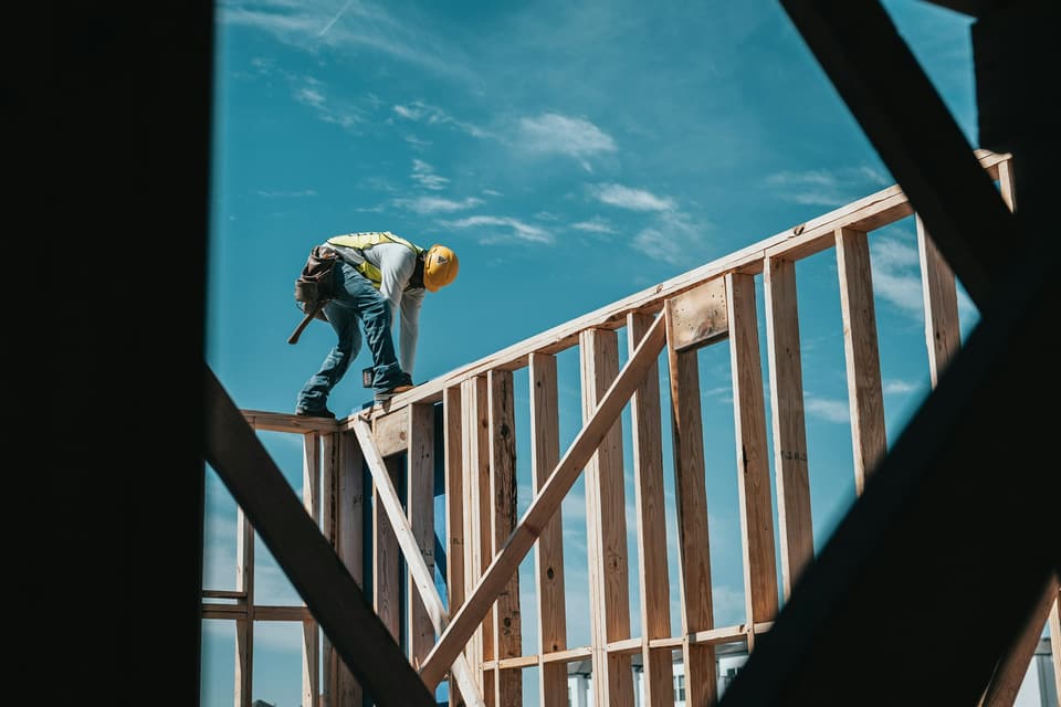 A construction crew framing a house