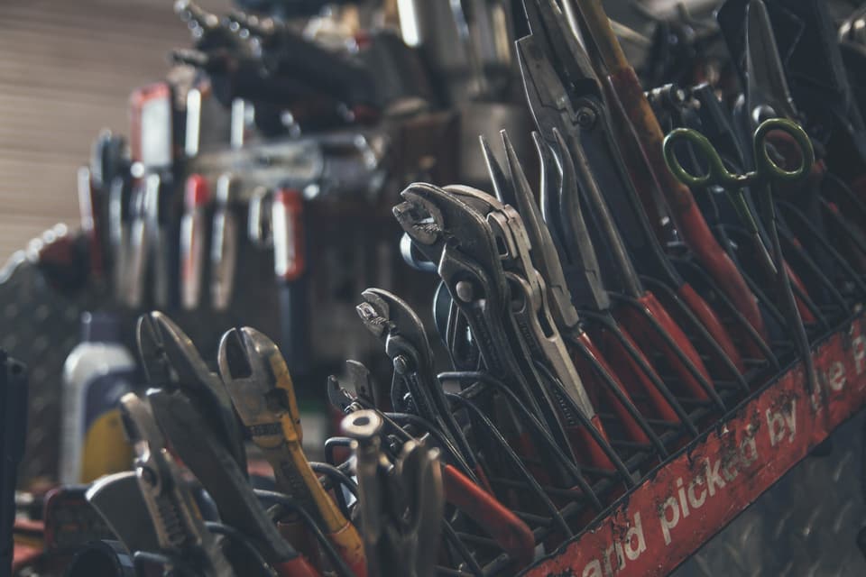 Hand tools arranged on a rack in a workshop
